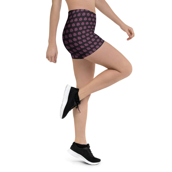 Action shot with leg raised – showcasing flexibility and style in Eyora psychedelic shorts.