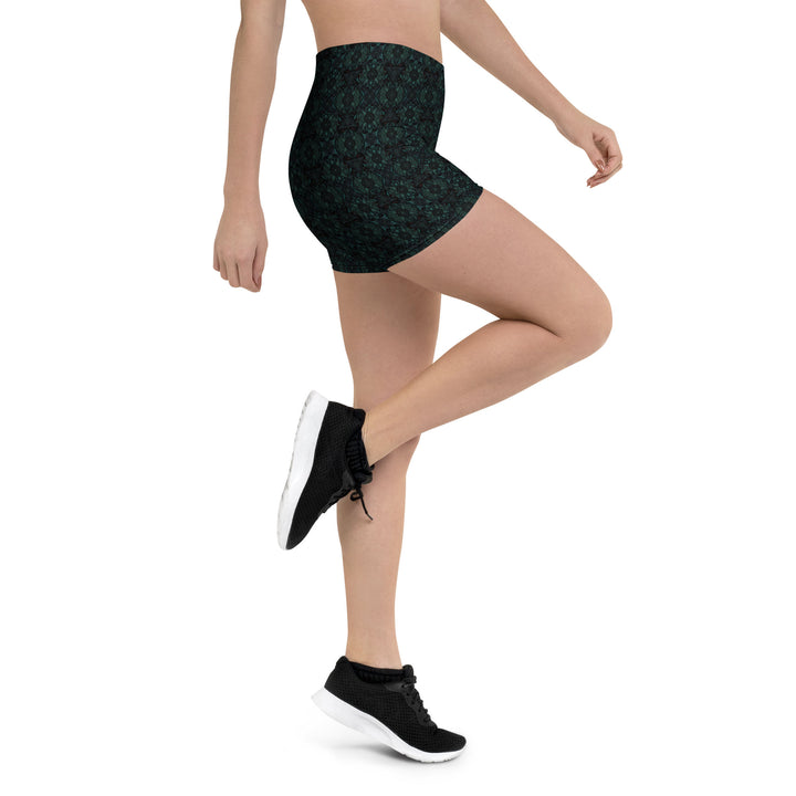 Action shot with leg raised – showcasing flexibility and style in Lumora psychedelic shorts.