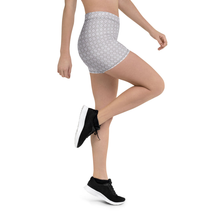 Action shot with leg raised – flexible and expressive fit in Netra psychedelic third-eye shorts.
