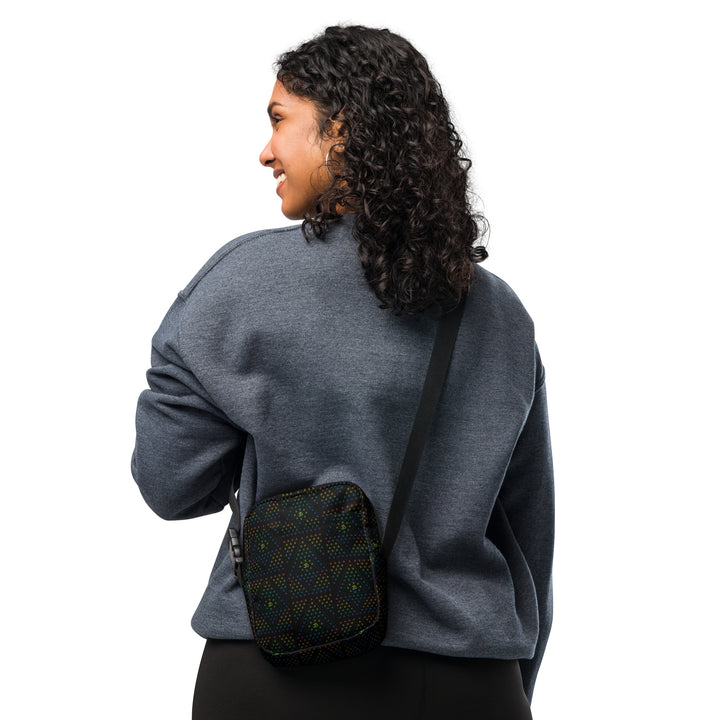 Person wearing GeOm Black psychedelic crossbody bag – sacred geometry style for festivals and travel