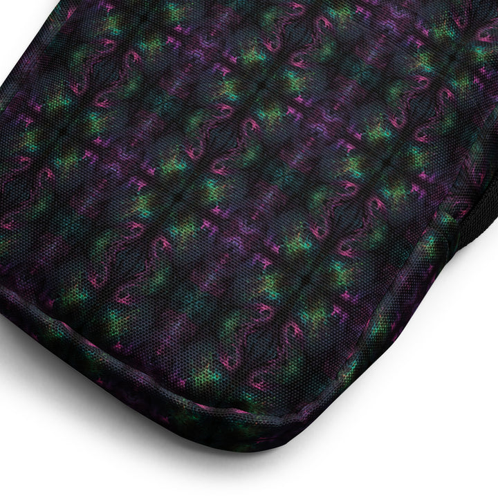 Close-up of Nebulith fabric – intricate sacred geometry in glowing hues for trippy fashion lovers